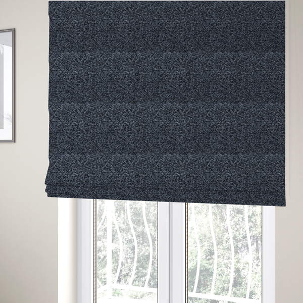 The fabric used to create these Roman blinds is a textured fabric surface. The material features a dense, nubby appearance with a speckled, multi-tonal colour palette of dark navy blue, charcoal, and light grey fibres, characteristic of heavy-duty carpeting or upholstery.