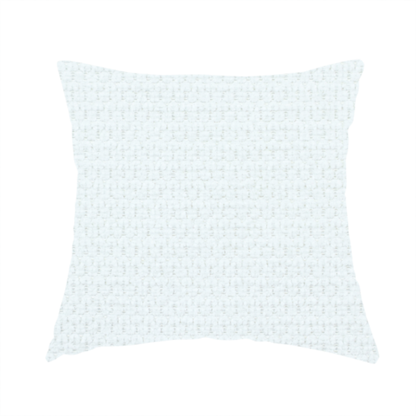 The fabric used to create this handmade cushion is a white, textured fabric with a dense, rhythmic pattern. The material features a honeycomb or waffle-weave structure, where small, uniform raised circles create a grid-like tactile surface. The colour is a bright, cool-toned white, and the subtle shadows within the weave give the fabric a soft, multidimensional appearance.