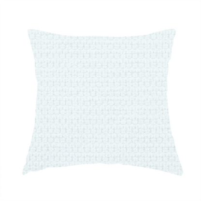 The fabric used to create this handmade cushion is a white, textured fabric with a dense, rhythmic pattern. The material features a honeycomb or waffle-weave structure, where small, uniform raised circles create a grid-like tactile surface. The colour is a bright, cool-toned white, and the subtle shadows within the weave give the fabric a soft, multidimensional appearance.