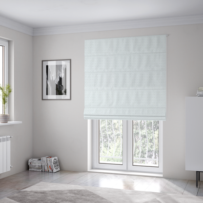 The fabric used to create these Roman blinds is a white, textured fabric with a dense, rhythmic pattern. The material features a honeycomb or waffle-weave structure, where small, uniform raised circles create a grid-like tactile surface. The colour is a bright, cool-toned white, and the subtle shadows within the weave give the fabric a soft, multidimensional appearance.