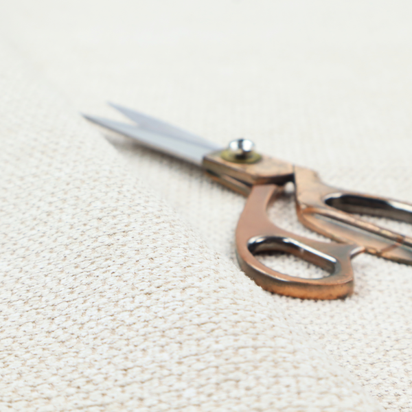 A warm cream or off-white tone. The material features a chunky, heavyweight weave with a distinct dimensional grid. The texture is composed of thick, interlaced threads that create a series of small, raised rectangular bumps, giving it a basket weave or bouclé-like appearance.