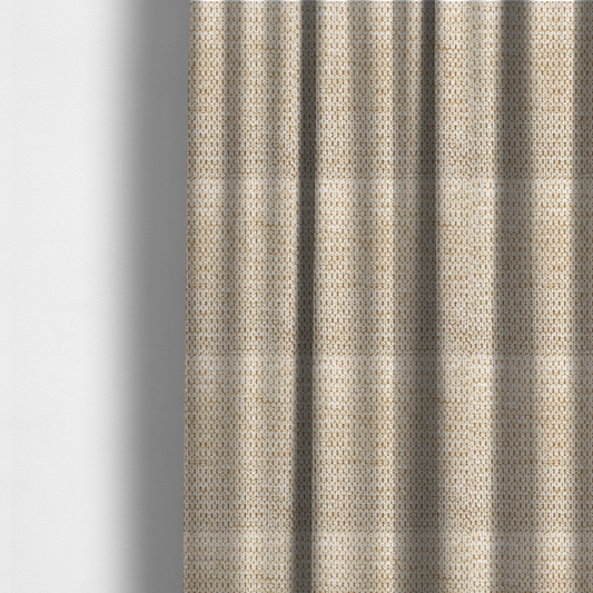 The fabric used to create these made-to-measure curtains is a textured, multi-tonal beige and tan fabric. The material features a tight, intricate weave that creates a pebbled or "seed stitch" appearance. The colour is a warm sand or wheat palette, achieved by interlacing light cream threads with darker tan or straw-coloured fibres, giving the fabric a rich, organic depth.