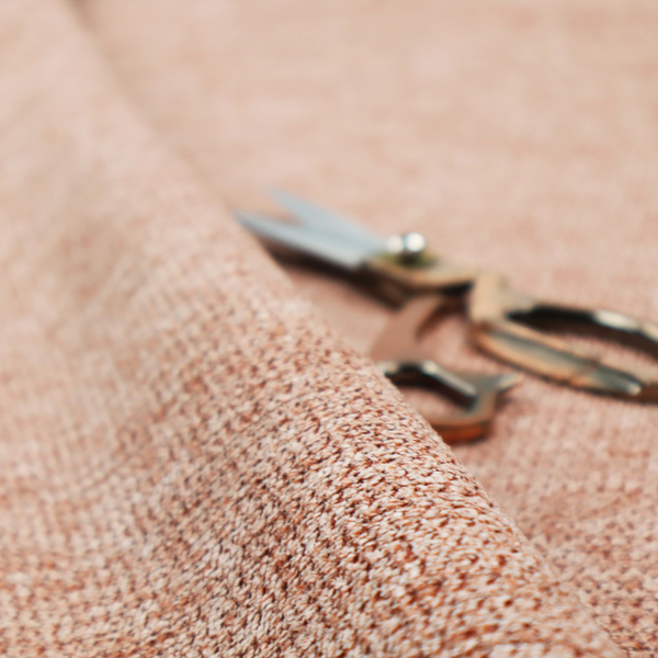 A textured, multi-tonal terracotta and cream fabric. The material features a dense, rhythmic weave that creates a speckled or "salt and pepper" effect. The colour is a warm, earthy copper palette, achieved by blending burnt orange or clay-coloured threads with lighter off-white fibres for a rich, weathered appearance.