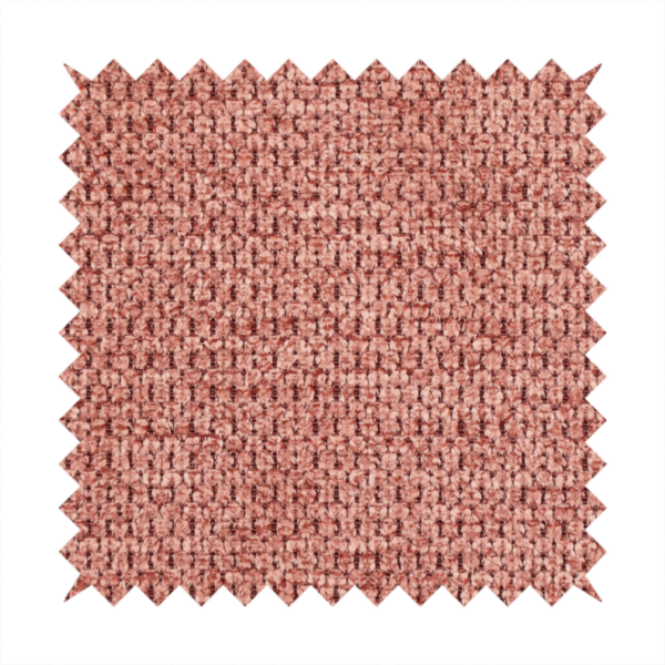 A textured fabric in a muted rose or dusty clay tone. The material features a dense, rhythmic weave with a tactile, pebbled surface. The colour is a sophisticated, warm mauve, created by interlacing deep pinkish-brown threads with lighter rose fibres, giving it a weathered, multi-dimensional look.
