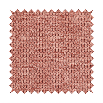 A textured fabric in a muted rose or dusty clay tone. The material features a dense, rhythmic weave with a tactile, pebbled surface. The colour is a sophisticated, warm mauve, created by interlacing deep pinkish-brown threads with lighter rose fibres, giving it a weathered, multi-dimensional look.
