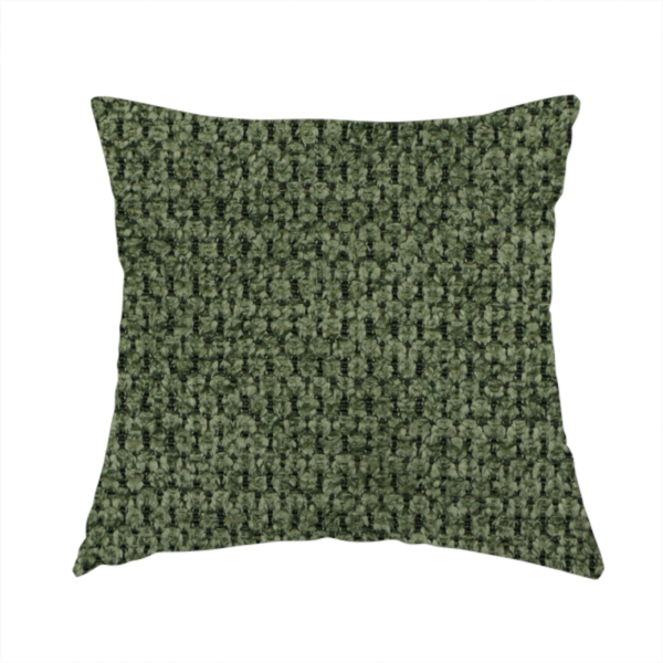 The fabric used to create this handmade cushion is a textured fabric in a deep forest or moss green tone. The material features a dense, rhythmic weave with a prominent tactile surface. The colour is a rich, moody evergreen, achieved by interlacing dark green threads with subtle black or charcoal base fibres, creating a sophisticated, shadowed depth throughout the honeycomb-like pattern.