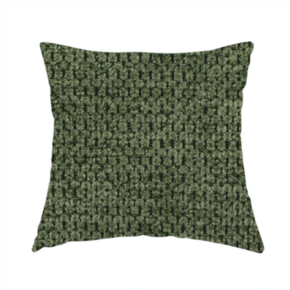 The fabric used to create this handmade cushion is a textured fabric in a deep forest or moss green tone. The material features a dense, rhythmic weave with a prominent tactile surface. The colour is a rich, moody evergreen, achieved by interlacing dark green threads with subtle black or charcoal base fibres, creating a sophisticated, shadowed depth throughout the honeycomb-like pattern.