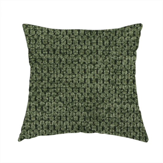 The fabric used to create this handmade cushion is a textured fabric in a deep forest or moss green tone. The material features a dense, rhythmic weave with a prominent tactile surface. The colour is a rich, moody evergreen, achieved by interlacing dark green threads with subtle black or charcoal base fibres, creating a sophisticated, shadowed depth throughout the honeycomb-like pattern.