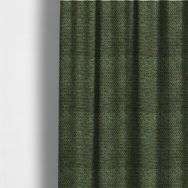 The fabric used to create these made-to-measure curtains is a textured fabric in a deep forest or moss green tone. The material features a dense, rhythmic weave with a prominent tactile surface. The colour is a rich, moody evergreen, achieved by interlacing dark green threads with subtle black or charcoal base fibres, creating a sophisticated, shadowed depth throughout the honeycomb-like pattern.