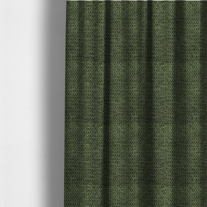 The fabric used to create these made-to-measure curtains is a textured fabric in a deep forest or moss green tone. The material features a dense, rhythmic weave with a prominent tactile surface. The colour is a rich, moody evergreen, achieved by interlacing dark green threads with subtle black or charcoal base fibres, creating a sophisticated, shadowed depth throughout the honeycomb-like pattern.