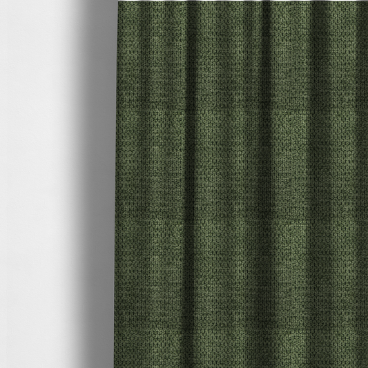 The fabric used to create these made-to-measure curtains is a textured fabric in a deep forest or moss green tone. The material features a dense, rhythmic weave with a prominent tactile surface. The colour is a rich, moody evergreen, achieved by interlacing dark green threads with subtle black or charcoal base fibres, creating a sophisticated, shadowed depth throughout the honeycomb-like pattern.