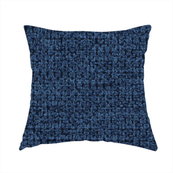 The fabric used to create this handmade cushion is a textured fabric in a deep navy or midnight blue tone. The material features a dense, rhythmic weave with a prominent tactile surface. The colour is a rich, saturated indigo, achieved by interlacing vibrant blue threads with darker charcoal base fibres, creating a sophisticated, shadowed depth throughout the honeycomb-like pattern.