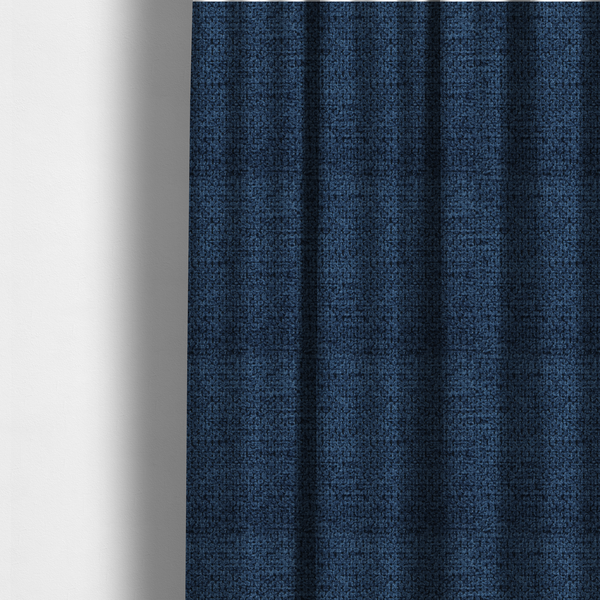 The fabric used to create these made-to-measure curtains is a textured fabric in a deep navy or midnight blue tone. The material features a dense, rhythmic weave with a prominent tactile surface. The colour is a rich, saturated indigo, achieved by interlacing vibrant blue threads with darker charcoal base fibres, creating a sophisticated, shadowed depth throughout the honeycomb-like pattern.