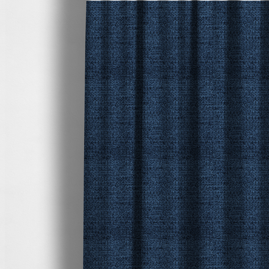 The fabric used to create these made-to-measure curtains is a textured fabric in a deep navy or midnight blue tone. The material features a dense, rhythmic weave with a prominent tactile surface. The colour is a rich, saturated indigo, achieved by interlacing vibrant blue threads with darker charcoal base fibres, creating a sophisticated, shadowed depth throughout the honeycomb-like pattern.