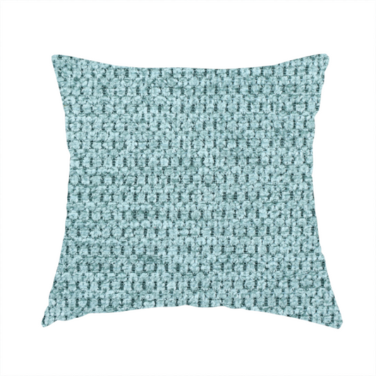 The fabric used to create this handmade cushion is a textured fabric in a vibrant aqua or light teal tone. This material features a dense, rhythmic weave with a prominent tactile surface. The colour is a refreshing seafoam blue, achieved by interlacing bright aqua threads with subtle grey base fibres, creating a weathered, multidimensional look that feels energetic yet sophisticated.