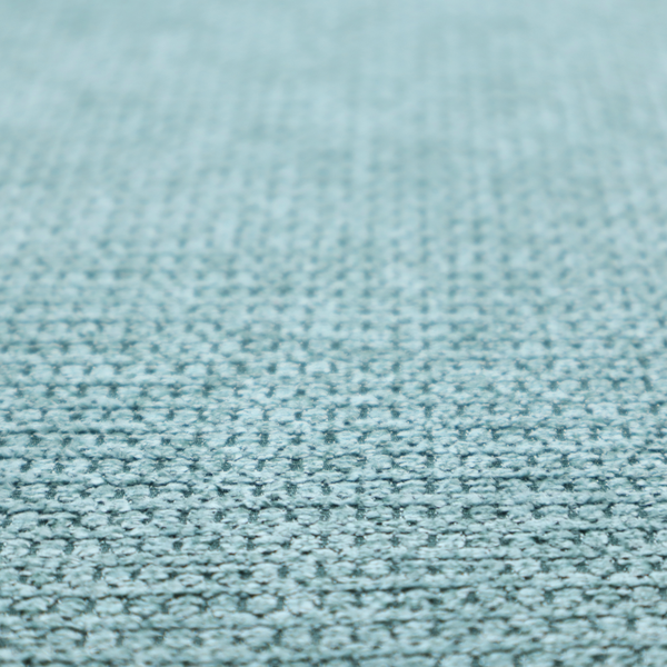 A textured fabric in a vibrant aqua or light teal tone. This material features a dense, rhythmic weave with a prominent tactile surface. The colour is a refreshing seafoam blue, achieved by interlacing bright aqua threads with subtle grey base fibres, creating a weathered, multidimensional look that feels energetic yet sophisticated.