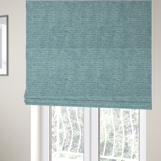 The fabric used to create these Roman blinds is a textured fabric in a vibrant aqua or light teal tone. This material features a dense, rhythmic weave with a prominent tactile surface. The colour is a refreshing seafoam blue, achieved by interlacing bright aqua threads with subtle grey base fibres, creating a weathered, multidimensional look that feels energetic yet sophisticated.