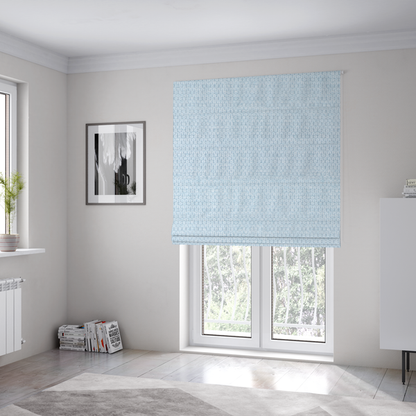 The fabric used to create these Roman blinds is a textured fabric in a pale sky blue. This material features a dense, rhythmic weave with a delicate honeycomb-like surface. The colour is a bright, airy pastel blue, achieved by interlacing soft blue threads with a crisp white base, resulting in a luminous, clean appearance that emphasizes the fabric's tactile grid.
