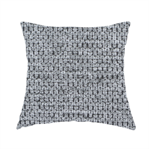 The fabric used to create this handmade cushion is a textured fabric in a classic charcoal or weathered grey. The material features a dense, rhythmic weave with a tactile, pebbled surface. The colour is a sophisticated mid-grey, achieved by interlacing silver-grey threads with darker black base fibres, creating a high-contrast, multidimensional look that feels balanced and durable.