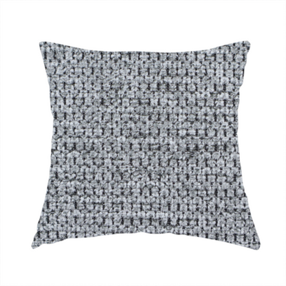 The fabric used to create this handmade cushion is a textured fabric in a classic charcoal or weathered grey. The material features a dense, rhythmic weave with a tactile, pebbled surface. The colour is a sophisticated mid-grey, achieved by interlacing silver-grey threads with darker black base fibres, creating a high-contrast, multidimensional look that feels balanced and durable.
