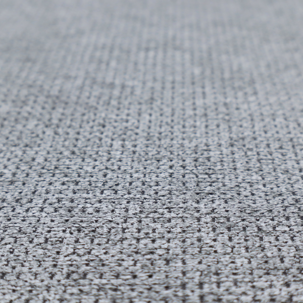 A textured fabric in a classic charcoal or weathered grey. The material features a dense, rhythmic weave with a tactile, pebbled surface. The colour is a sophisticated mid-grey, achieved by interlacing silver-grey threads with darker black base fibres, creating a high-contrast, multidimensional look that feels balanced and durable.