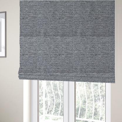 The fabric used to create these Roman blinds is a textured fabric in a classic charcoal or weathered grey. The material features a dense, rhythmic weave with a tactile, pebbled surface. The colour is a sophisticated mid-grey, achieved by interlacing silver-grey threads with darker black base fibres, creating a high-contrast, multidimensional look that feels balanced and durable.