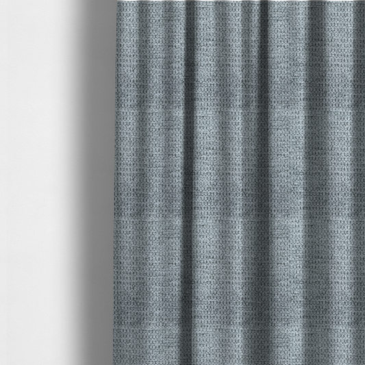 The fabric used to create these made-to-measure curtains is a cool-toned, silver-grey weave with subtle dark lowlights.