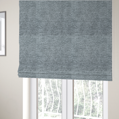 The fabric used to create these Roman blinds is a cool-toned, silver-grey weave with subtle dark lowlights.