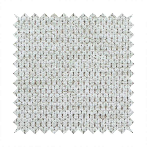 A textured fabric in light greige or pale oatmeal. The material features a dense, rhythmic honeycomb weave. The colour is achieved by interlacing light cream threads with cool grey base fibres, creating a neutral, stony appearance with a soft, pebbled tactile surface.