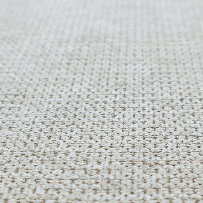 A textured fabric in light greige or pale oatmeal. The material features a dense, rhythmic honeycomb weave. The colour is achieved by interlacing light cream threads with cool grey base fibres, creating a neutral, stony appearance with a soft, pebbled tactile surface.