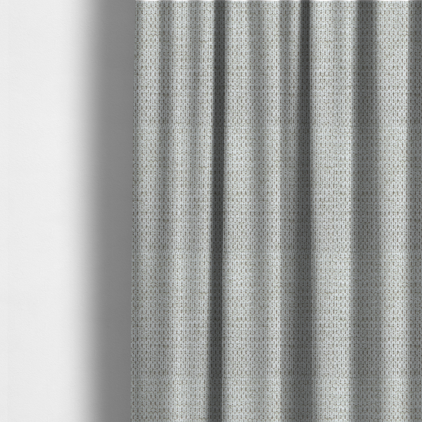 The fabric used to create these made-to-measure curtains is a textured fabric in light greige or pale oatmeal. The material features a dense, rhythmic honeycomb weave. The colour is achieved by interlacing light cream threads with cool grey base fibres, creating a neutral, stony appearance with a soft, pebbled tactile surface.