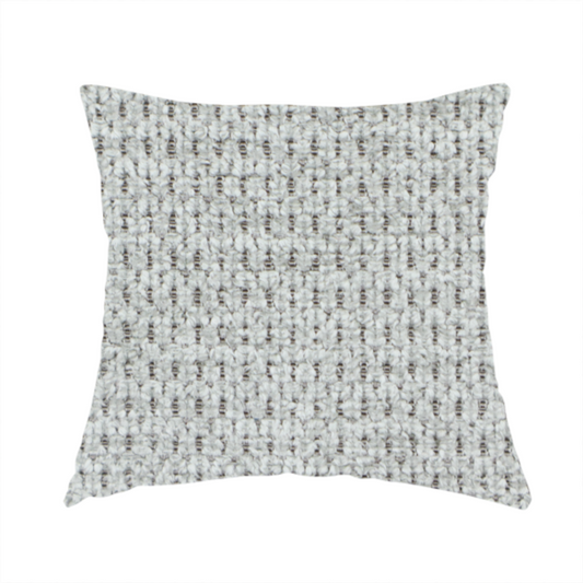 The fabric used to create this handmade cushion is a textured fabric in a soft dove grey. This swatch features the signature uniform honeycomb weave, but with a lighter, more silver-toned profile than the previous neutral. The interlacing of white and light grey threads gives it a crisp, clean, and airy aesthetic.