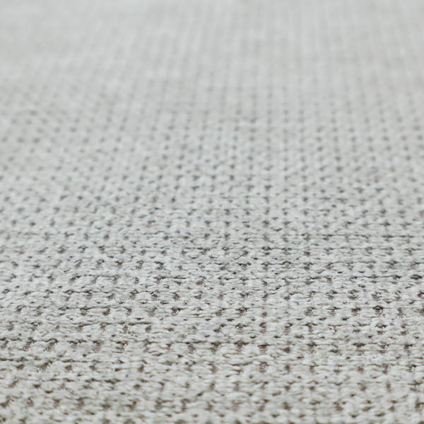 A textured fabric in a soft dove grey. This swatch features the signature uniform honeycomb weave, but with a lighter, more silver-toned profile than the previous neutral. The interlacing of white and light grey threads gives it a crisp, clean, and airy aesthetic.