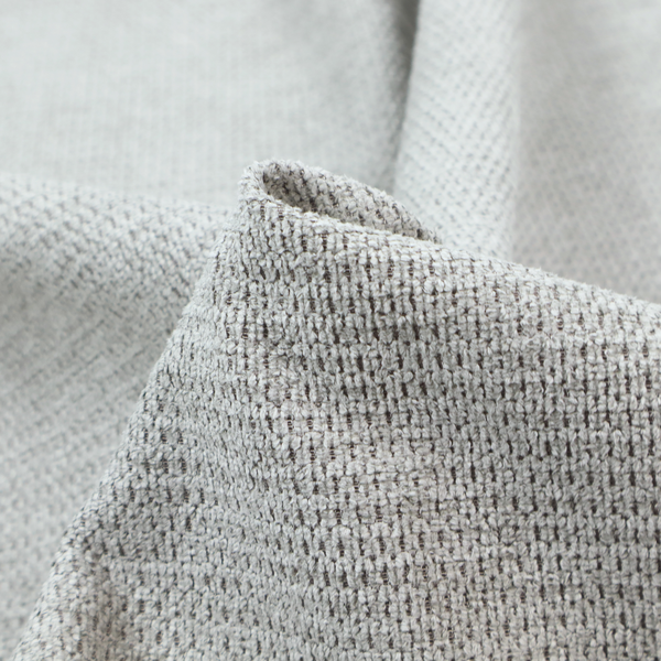 A textured fabric in a soft dove grey. This swatch features the signature uniform honeycomb weave, but with a lighter, more silver-toned profile than the previous neutral. The interlacing of white and light grey threads gives it a crisp, clean, and airy aesthetic.