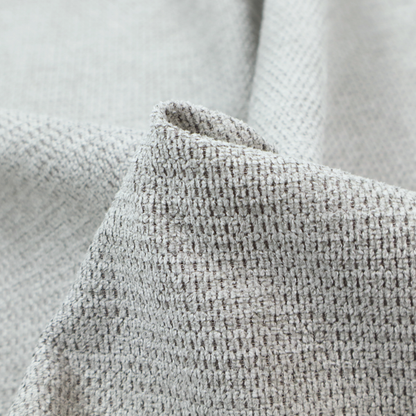A textured fabric in a soft dove grey. This swatch features the signature uniform honeycomb weave, but with a lighter, more silver-toned profile than the previous neutral. The interlacing of white and light grey threads gives it a crisp, clean, and airy aesthetic.