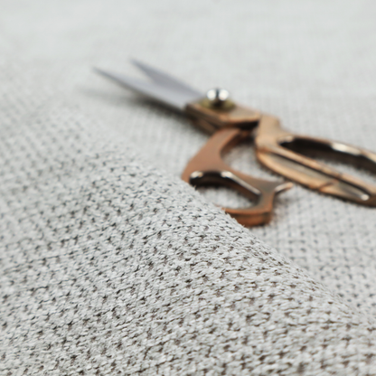 A textured fabric in a soft dove grey. This swatch features the signature uniform honeycomb weave, but with a lighter, more silver-toned profile than the previous neutral. The interlacing of white and light grey threads gives it a crisp, clean, and airy aesthetic.