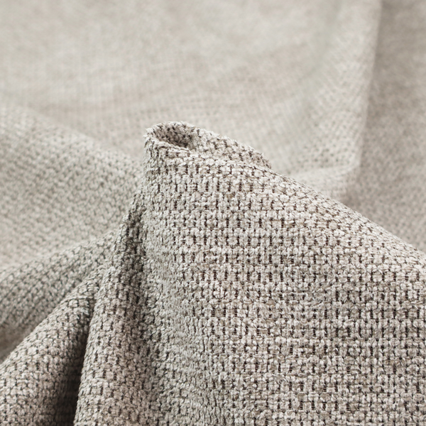 A textured fabric in a warm stone or soft taupe tone. This material features the collection's signature dense, rhythmic honeycomb weave. The colour is a sophisticated neutral mushroom, achieved by interlacing light cream and flax-coloured threads over a darker tan base, creating a grainy, organic depth that feels both earthy and modern.
