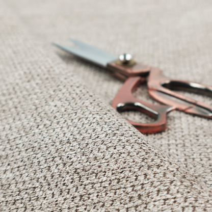 A textured fabric in a warm stone or soft taupe tone. This material features the collection's signature dense, rhythmic honeycomb weave. The colour is a sophisticated neutral mushroom, achieved by interlacing light cream and flax-coloured threads over a darker tan base, creating a grainy, organic depth that feels both earthy and modern.