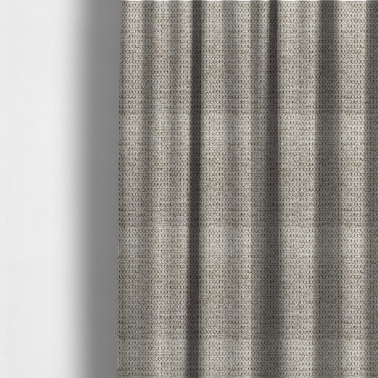The fabric used to create these made-to-measure curtains is a textured fabric in a warm stone or soft taupe tone. This material features the collection's signature dense, rhythmic honeycomb weave. The colour is a sophisticated neutral mushroom, achieved by interlacing light cream and flax-coloured threads over a darker tan base, creating a grainy, organic depth that feels both earthy and modern.