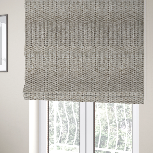 The fabric used to create these Roman blinds is a textured fabric in a warm stone or soft taupe tone. This material features the collection's signature dense, rhythmic honeycomb weave. The colour is a sophisticated neutral mushroom, achieved by interlacing light cream and flax-coloured threads over a darker tan base, creating a grainy, organic depth that feels both earthy and modern.