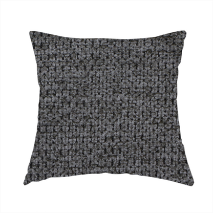 The fabric used to create this handmade cushion is a textured fabric in a deep charcoal or soft black tone. This swatch features the signature rhythmic honeycomb weave of the collection. The colour is a rich, dark obsidian, achieved by tightly interlacing black threads with very subtle dark grey highlights, creating a moody, high-relief surface that absorbs and reflects light in a sophisticated, matte-metallic way.