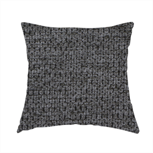 The fabric used to create this handmade cushion is a textured fabric in a deep charcoal or soft black tone. This swatch features the signature rhythmic honeycomb weave of the collection. The colour is a rich, dark obsidian, achieved by tightly interlacing black threads with very subtle dark grey highlights, creating a moody, high-relief surface that absorbs and reflects light in a sophisticated, matte-metallic way.
