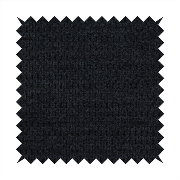 A textured fabric in midnight black. This swatch represents the deepest tone in the collection, featuring a uniform, tight waffle-weave. The monochromatic black threads create a subtle play of shadow within the geometric grid, offering a sleek, architectural aesthetic.