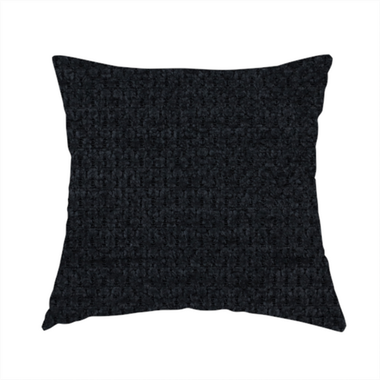 The fabric used to create this handmade cushion is a textured fabric in midnight black. This swatch represents the deepest tone in the collection, featuring a uniform, tight waffle-weave. The monochromatic black threads create a subtle play of shadow within the geometric grid, offering a sleek, architectural aesthetic.