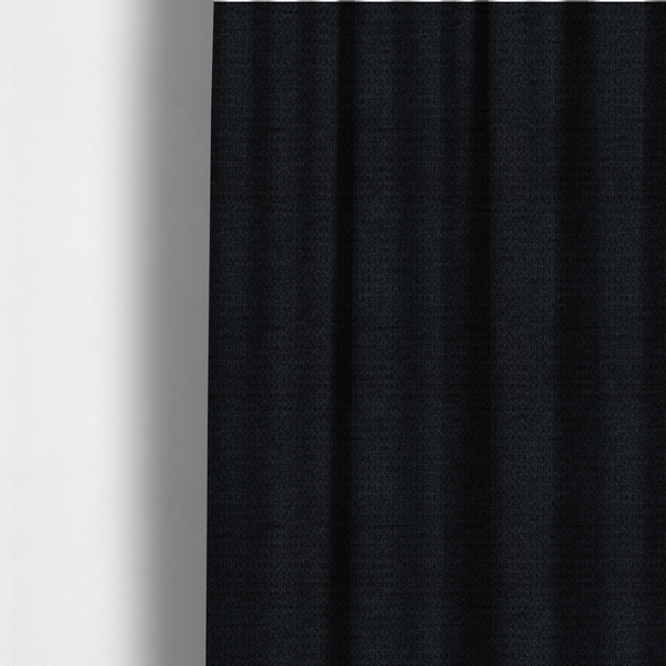 The fabric used to create these made-to-measure curtains is a textured fabric in midnight black. This swatch represents the deepest tone in the collection, featuring a uniform, tight waffle-weave. The monochromatic black threads create a subtle play of shadow within the geometric grid, offering a sleek, architectural aesthetic.