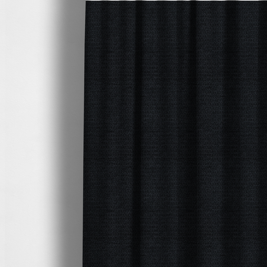 The fabric used to create these made-to-measure curtains is a textured fabric in midnight black. This swatch represents the deepest tone in the collection, featuring a uniform, tight waffle-weave. The monochromatic black threads create a subtle play of shadow within the geometric grid, offering a sleek, architectural aesthetic.