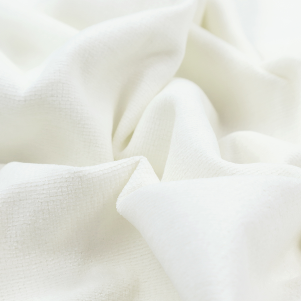 A pale off-white or cream-colored fabric featuring a fine, subtle grid-like texture. The weave consists of horizontal and vertical threads that create a soft, matte finish with a minimalist, clean aesthetic.