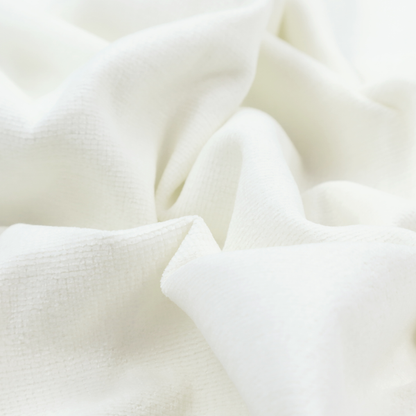 A pale off-white or cream-colored fabric featuring a fine, subtle grid-like texture. The weave consists of horizontal and vertical threads that create a soft, matte finish with a minimalist, clean aesthetic.