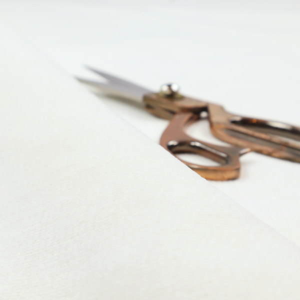 A pale off-white or cream-colored fabric featuring a fine, subtle grid-like texture. The weave consists of horizontal and vertical threads that create a soft, matte finish with a minimalist, clean aesthetic.