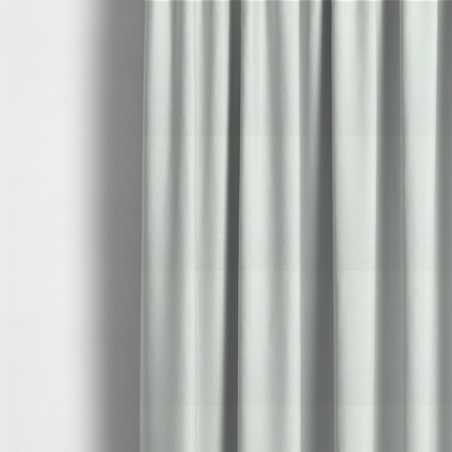 The fabric used to create these made-to-measure curtains is a pale off-white or cream-colored fabric featuring a fine, subtle grid-like texture. The weave consists of horizontal and vertical threads that create a soft, matte finish with a minimalist, clean aesthetic.